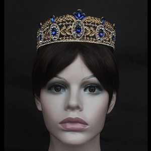 Detailed close-up of a gold bridal crown with deep blue crystals and white rhinestones