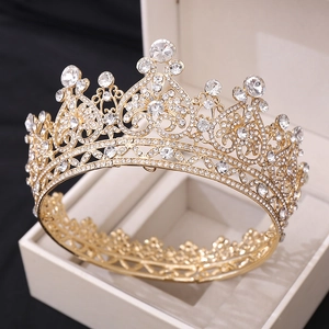 Close-up of golden Baroque bridal crown with crystals in a luxury jewelry box