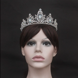 Close-up of silver bridal tiara featuring white beads and teardrop moonstone gems