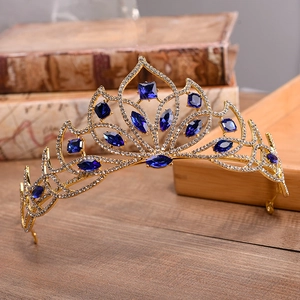 Macro view of bridal crown with blue gemstones and white rhinestones on vintage book
