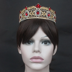 Detailed close-up of Baroque gold tiara with red pear-cut crystals and white zircons