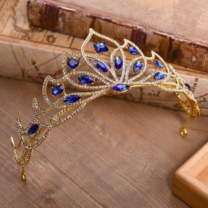 Detailed view of vintage gold bridal crown with deep blue crystals and white rhinestones