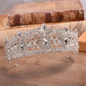 Macro detail of luxury silver crystal bridal crown with ornate Baroque leaf patterns