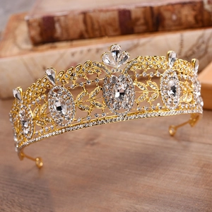 Macro view of crystal-encrusted gold bridal crown with intricate baroque alloy patterns
