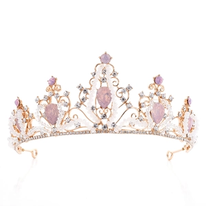 Elegant gold bridal tiara with pink crystals and pearls on white background