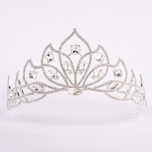 Macro detail of silver tiara showing intricate rhinestone petals and marquise crystals
