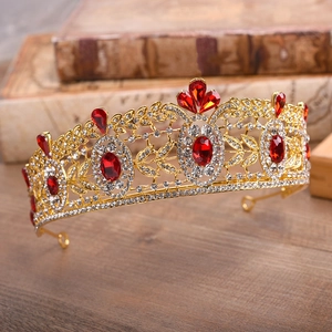 Close-up detail of luxury Baroque bridal crown with red crystals and floral gold alloy