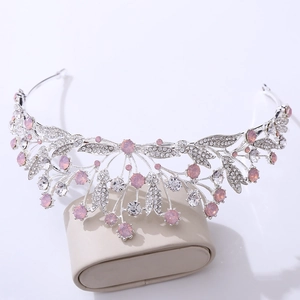 Close-up of silver leaf bridal tiara featuring pink crystals and clear rhinestones