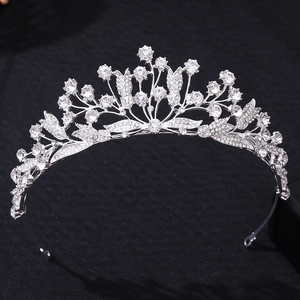 Close-up of vintage silver bridal tiara with intricate leaf design and sparkling rhinestones