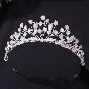 Detailed macro view of silver leaf crown with pink crystals and rhinestones for brides