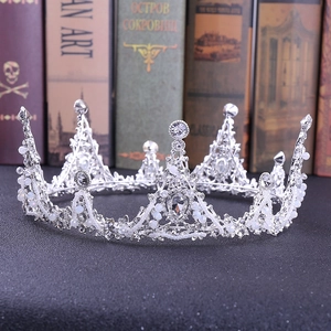 Baroque bridal crown with silver crystals and small pearls on vintage background