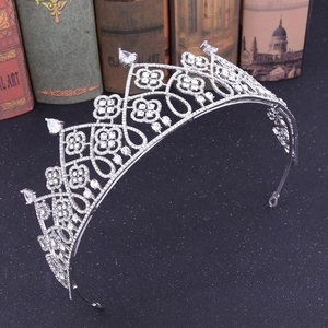 Elegant European style silver crown with white zircons and teardrop crystals on a dark base