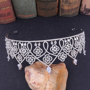 Detailed macro view of silver crown tiara with sparkling rhinestones and drop crystal pendants