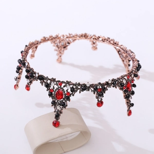 Close-up of Baroque bridal crown featuring red teardrop crystals and bronze metalwork