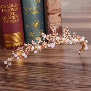 Rose gold handmade bridal crown with crystal branches and pearls on dark wood