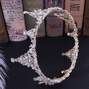 Detail of vintage gold bridal crown with white pearls and sparkling crystal rhinestones