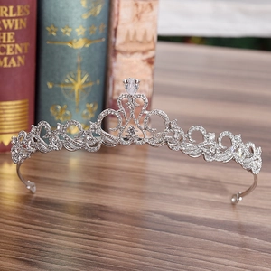 Elegant bridal crown with sparkling zircons and rhinestones on a vintage wooden background