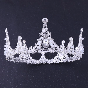 Close-up of Baroque silver crown featuring intricate metalwork, rhinestones, and white pearls