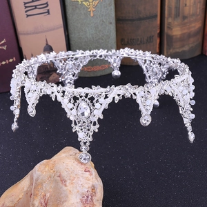Close-up of Baroque silver bridal tiara with pearls and crystal rhinestones on stone base