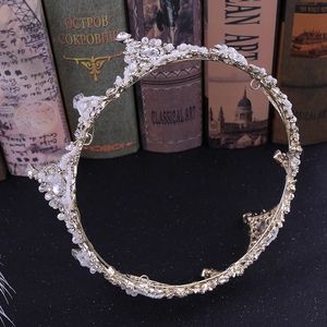 Detailed view of Baroque bridal crown with white pearls and crystals on vintage books