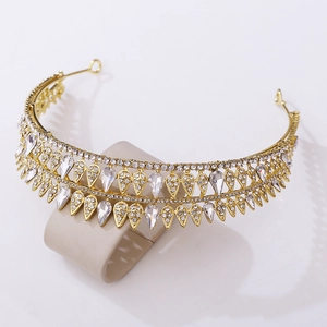 Detailed macro view of the golden bridal crown with teardrop crystals and rhinestones