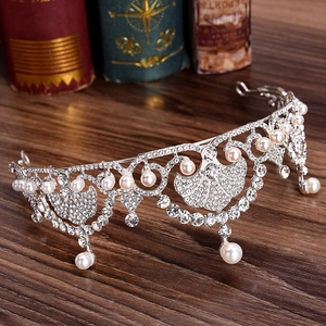 Elegant Baroque princess crown featuring white pearls and rhinestones on a vintage background