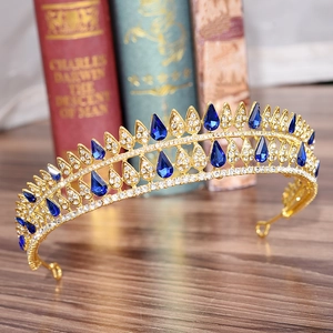 Macro view of gold bridal crown with blue teardrop crystals and sparkling rhinestones