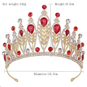 Detailed view of Baroque bridal crown with red teardrop gems and silver leaf design
