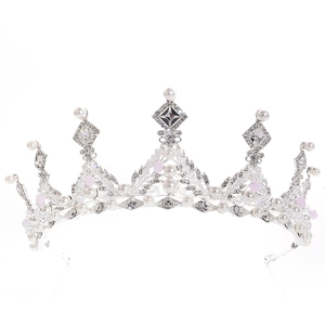 Close-up of elegant silver bridal crown with white pearls and sparkling rhinestones