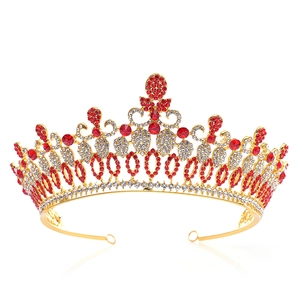 Luxurious gold Baroque bridal crown with red and white rhinestones on white background