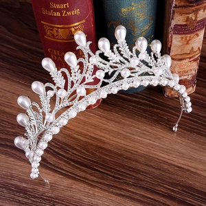 Elegant silver bridal crown with pearls and rhinestones on a vintage background