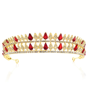Detail of baroque gold crown with teardrop red crystals and sparkling white rhinestones