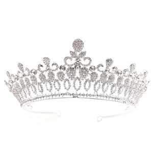 Close-up of Baroque silver bridal crown featuring intricate vine patterns and rhinestones