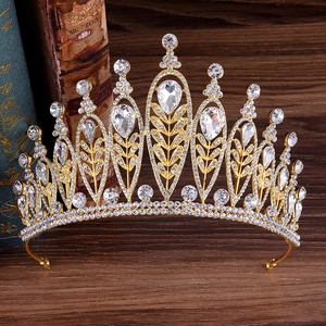 Macro detail of golden baroque crown with sparkling rhinestones on vintage books