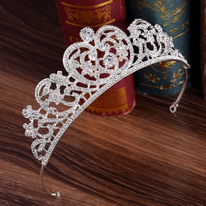 Elegant bridal alloy crown with sparkling rhinestones on vintage book background