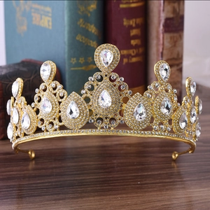 Close-up detail of golden bridal crown featuring teardrop crystals and vintage rhinestones