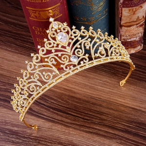 Makro-Detail einer luxuriösen Goldbrautkrone mit weißen Zirkonia auf Vintage-Büchern