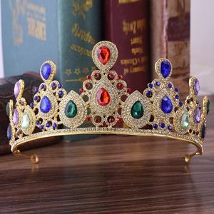 Luxurious gold alloy bridal crown with colorful teardrop rhinestones on dark wood