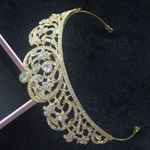 Detail of luxury bridal crown featuring gold baroque pattern and sparkling rhinestones