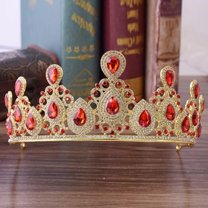 Elegant gold bridal crown featuring vibrant red rhinestones and white crystals on vintage books