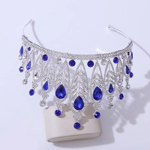 Detailed macro view of silver tiara featuring deep blue teardrop stones and leaf motifs