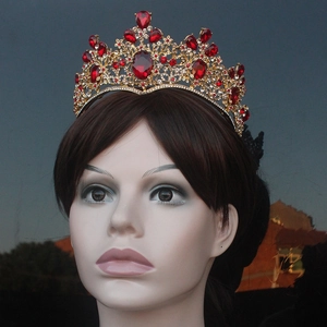 Close-up of baroque bridal crown with red gemstones and gold filigree details