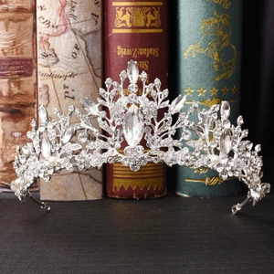Elegant bridal tiara with silver rhinestones and pearls on vintage books display
