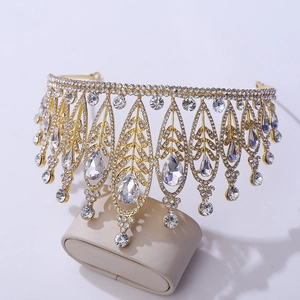 Close-up of Baroque gold crown featuring intricate leaf textures and crystal teardrops