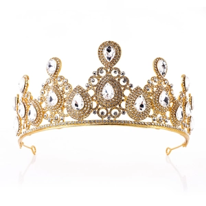 Detail of luxury bridal crown featuring golden metal frame and teardrop crystals