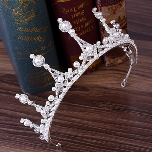 Detailed macro view of silver bridal tiara with rhinestones and white round pearls