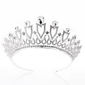 Close-up of a silver bridal crown featuring sparkling rhinestones and pear-cut crystals