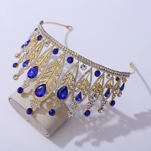 Detail of a golden Baroque bridal tiara with sparkling blue gemstones and clear crystals