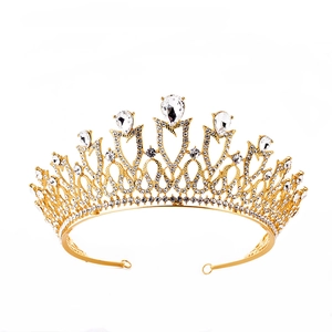 Close-up of golden alloy bridal tiara with sparkling rhinestones and drop-shaped gems