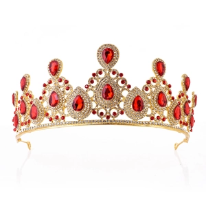 Detailed frontal view of golden bridal crown with red waterdrop gems and white rhinestones